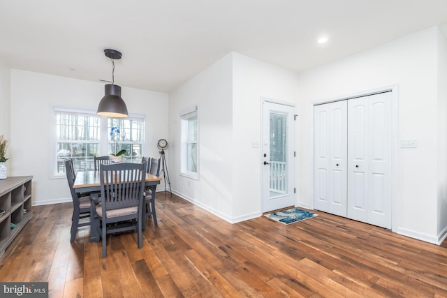 dining space with recessed lighting, wood-type flooring, and baseboards