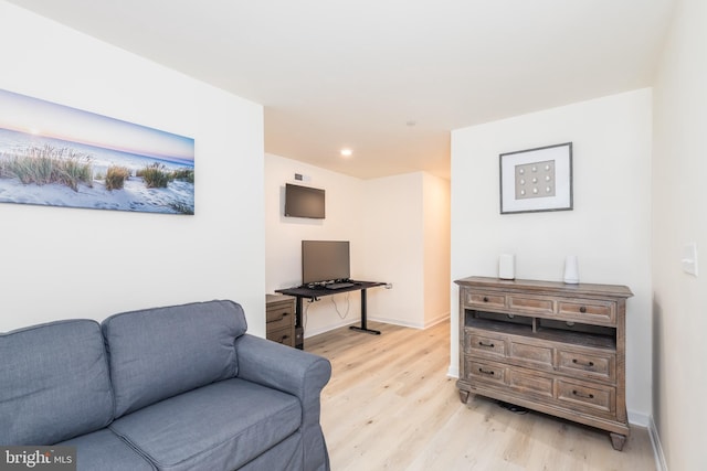 sitting room with light wood-style flooring and baseboards