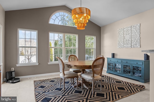 dining space with lofted ceiling, a notable chandelier, and baseboards