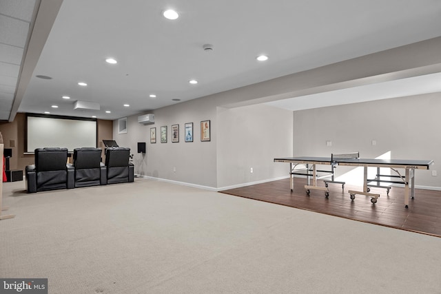 playroom with carpet floors, recessed lighting, a wall unit AC, and baseboards