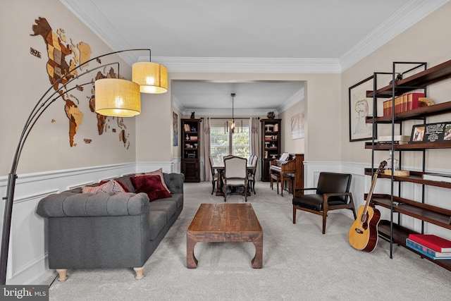 carpeted living room with ornamental molding and wainscoting