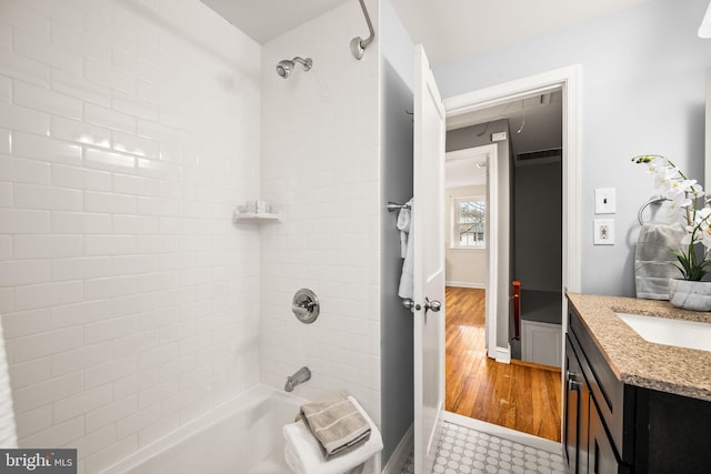 full bath with  shower combination, baseboards, and vanity