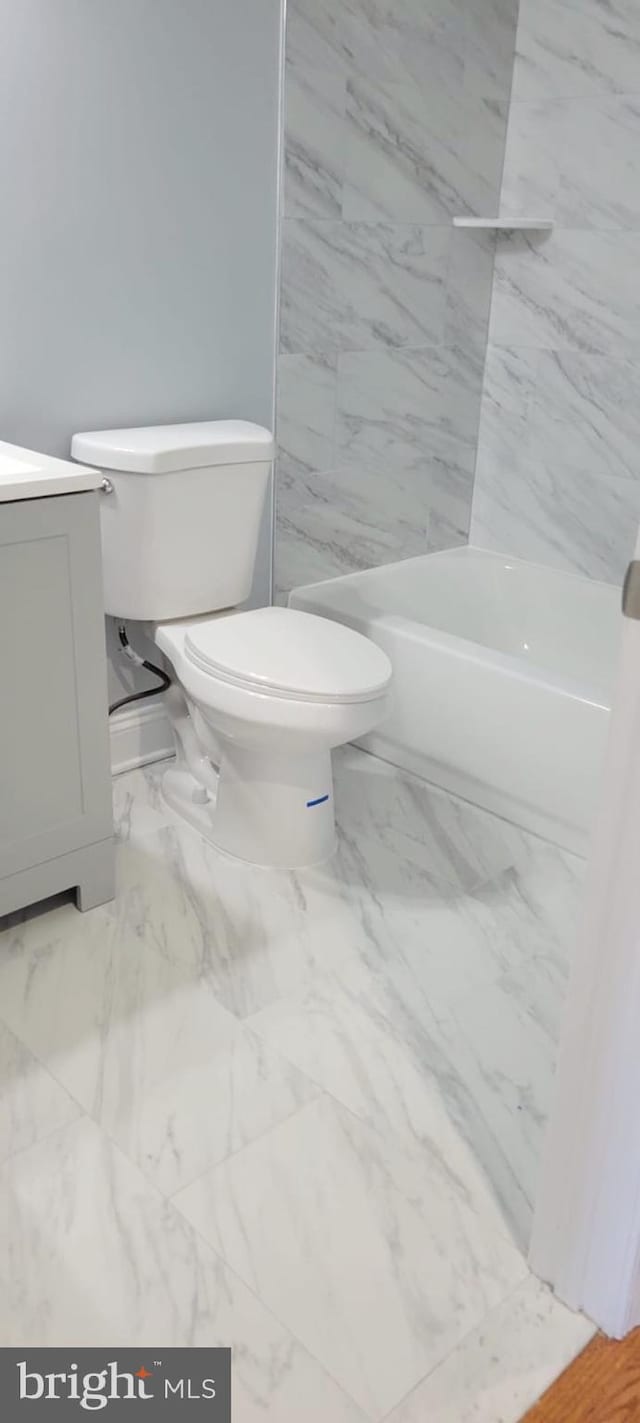 full bathroom with marble finish floor, vanity, and toilet