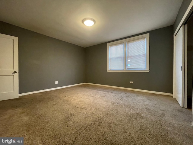 unfurnished bedroom with a closet and carpet flooring