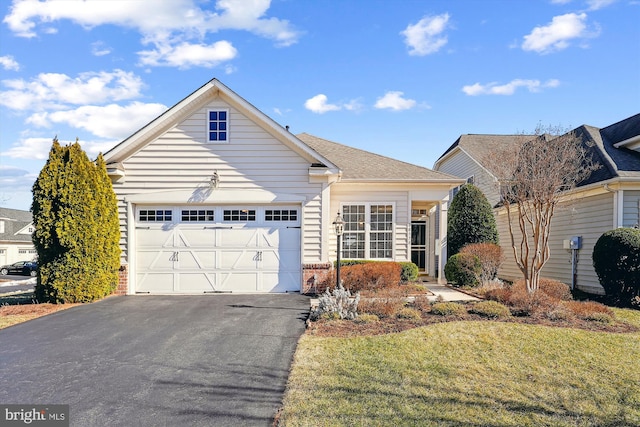 view of front facade featuring a garage and a front lawn