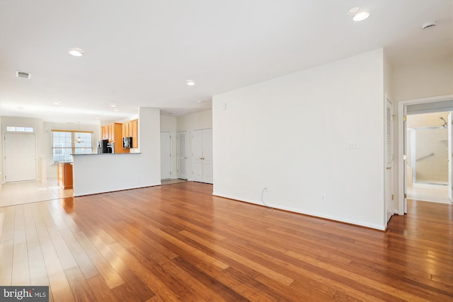 unfurnished living room with light hardwood / wood-style flooring