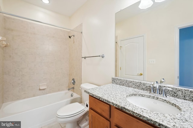 full bathroom with vanity, tiled shower / bath combo, and toilet