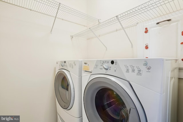 laundry area with washing machine and clothes dryer