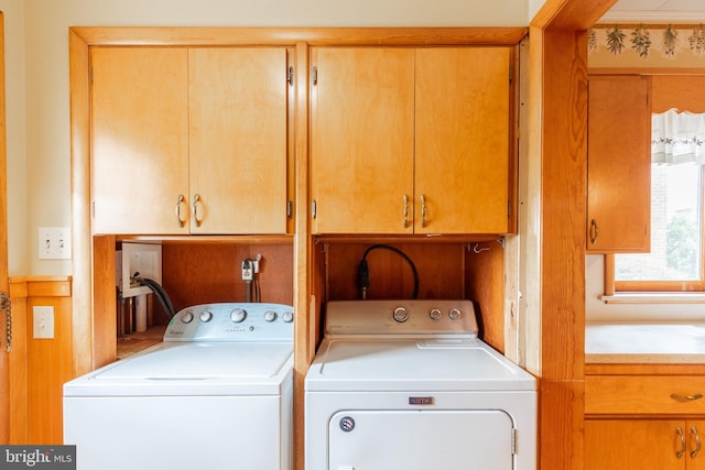 laundry area featuring cabinets and washing machine and clothes dryer