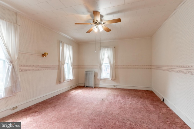 carpeted empty room with ornamental molding, radiator heating unit, and ceiling fan