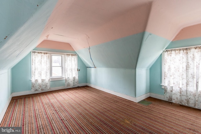 bonus room featuring lofted ceiling and carpet flooring