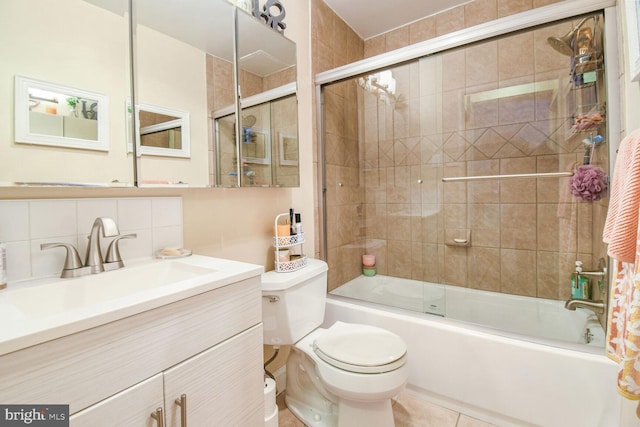 full bathroom featuring vanity, tile patterned flooring, toilet, shower / bath combination with glass door, and tasteful backsplash