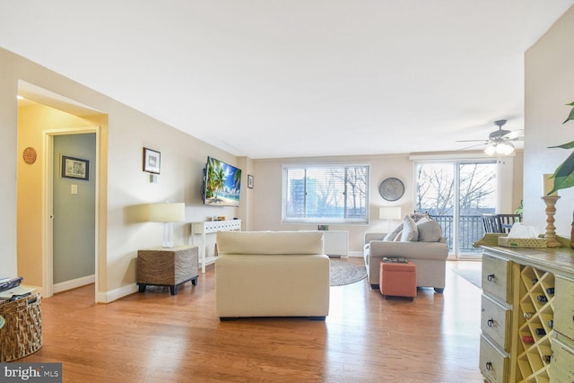 living room featuring hardwood / wood-style floors and ceiling fan