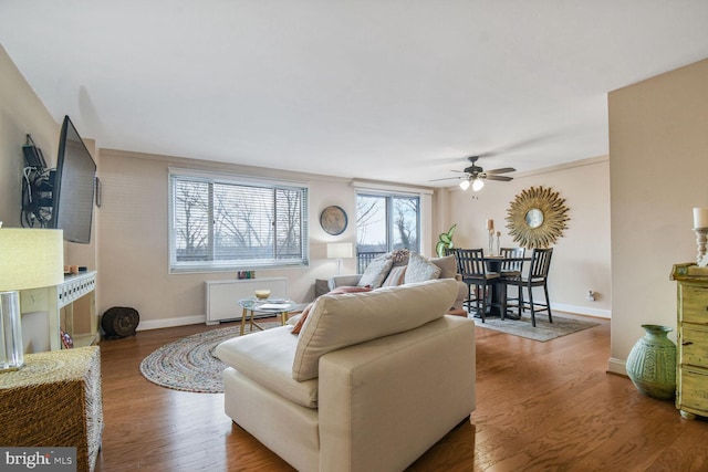 living room featuring hardwood / wood-style flooring and ceiling fan