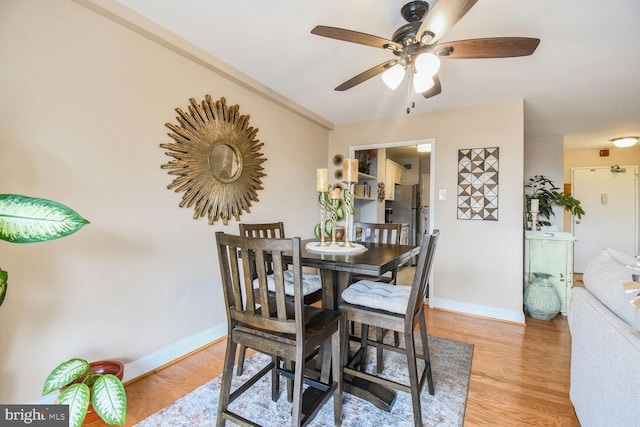 dining room with light wood-type flooring and ceiling fan