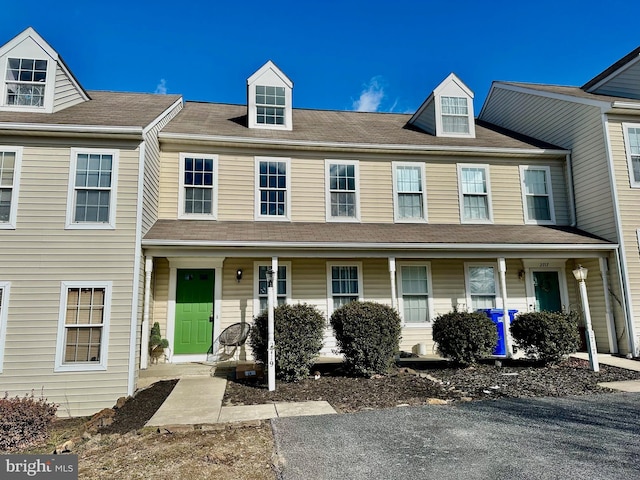 townhome / multi-family property featuring covered porch