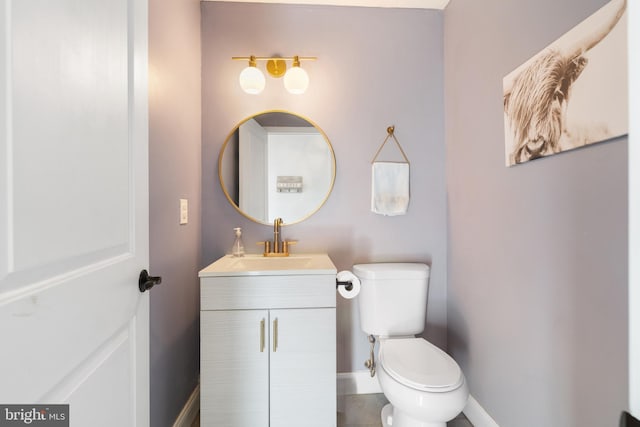 bathroom featuring toilet and vanity