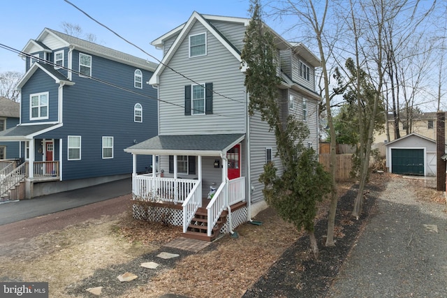 front facade featuring a garage, an outdoor structure, and a porch