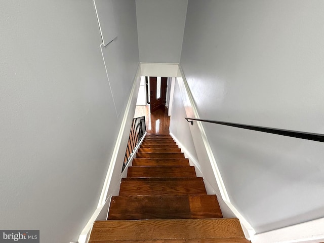 stairs featuring wood finished floors