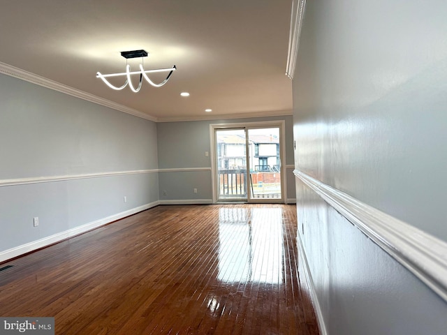 spare room featuring baseboards, recessed lighting, wood-type flooring, and crown molding