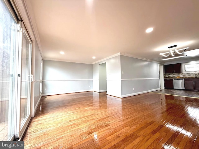 unfurnished room featuring dark wood-type flooring, recessed lighting, crown molding, and baseboards