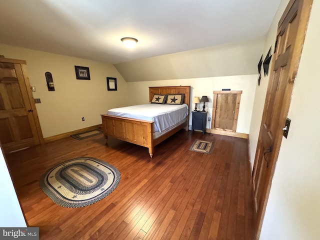 bedroom featuring lofted ceiling and dark wood-type flooring