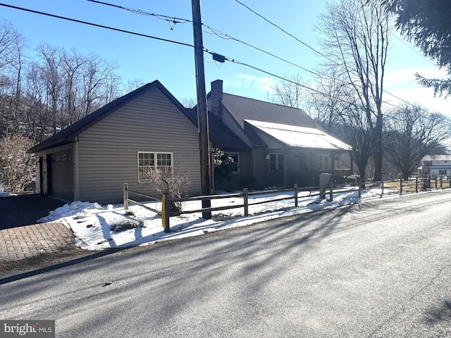 view of snow covered exterior featuring a garage