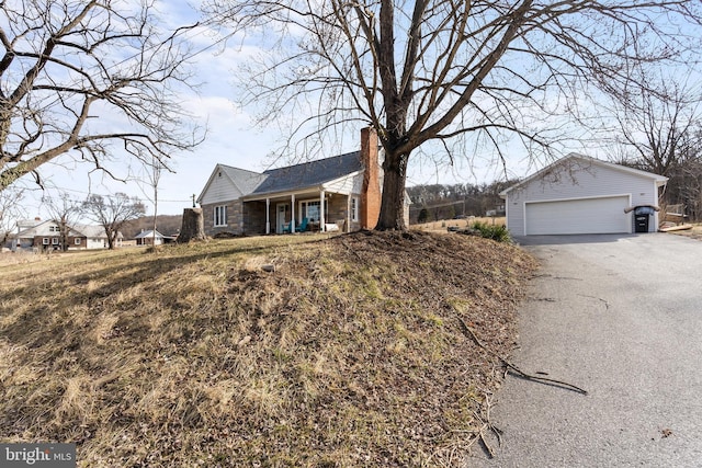 single story home with a garage, stone siding, and a chimney