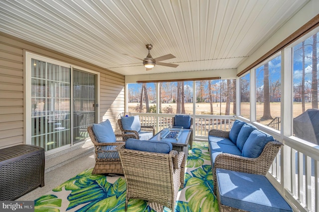 sunroom featuring a ceiling fan