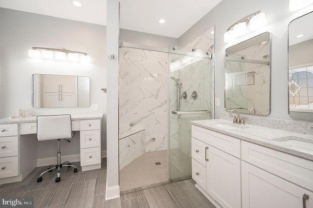 full bathroom featuring recessed lighting, a sink, a marble finish shower, and double vanity