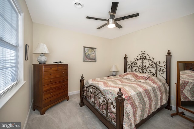 carpeted bedroom with visible vents, ceiling fan, and baseboards