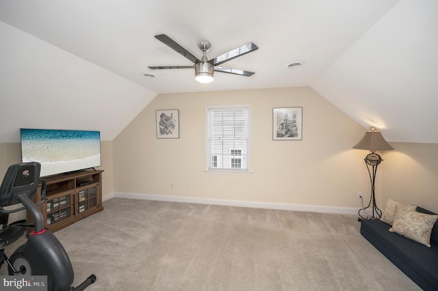 additional living space with baseboards, a ceiling fan, and light colored carpet