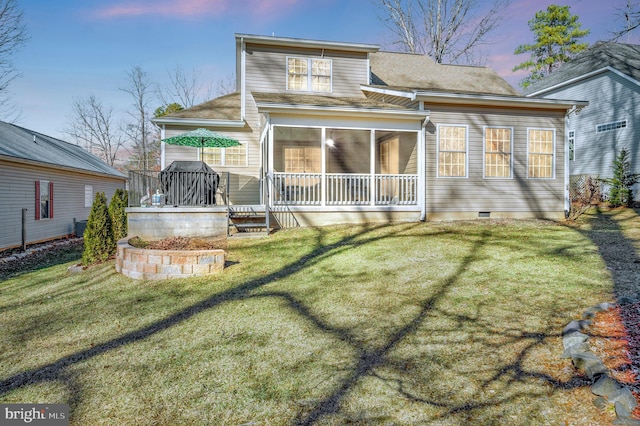 back of house featuring crawl space, a lawn, and a sunroom