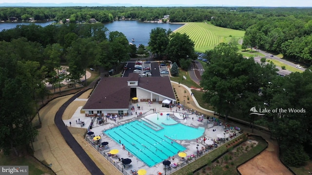 birds eye view of property with a water view and a view of trees