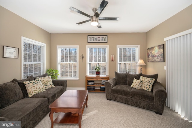 carpeted living room featuring a ceiling fan