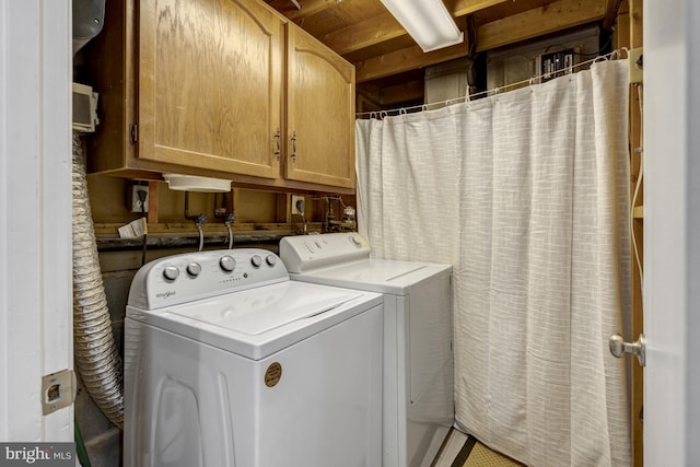 laundry room with cabinet space and washing machine and clothes dryer