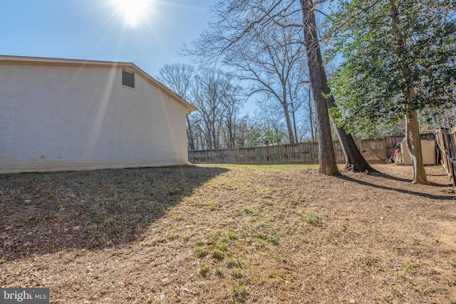 view of yard with a fenced backyard