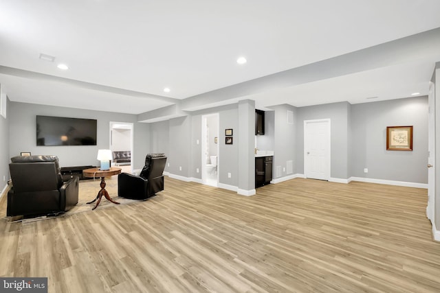 living room featuring bar and light wood-type flooring