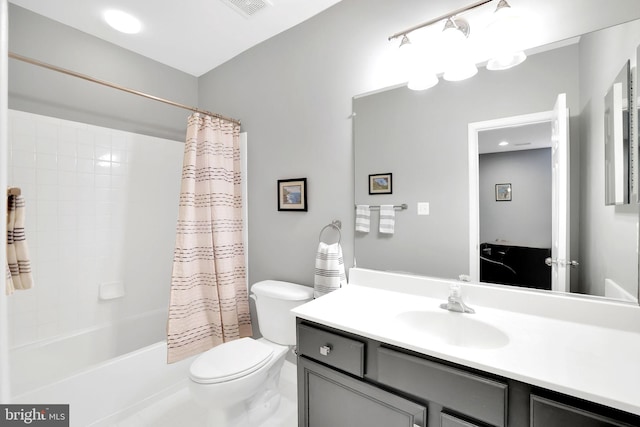 full bathroom with shower / bath combination with curtain, vanity, and toilet