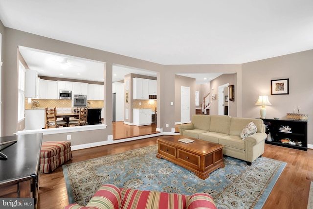 living room featuring sink and light hardwood / wood-style flooring