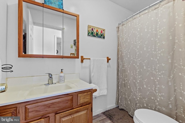 bathroom with vanity, curtained shower, wood-type flooring, and toilet