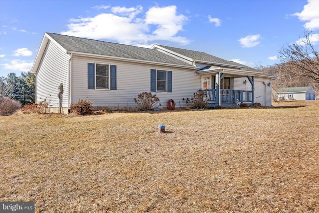 ranch-style house with a garage, a porch, and a front lawn