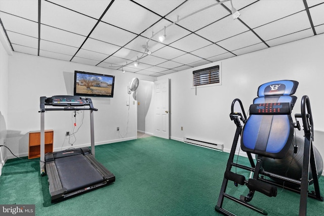 workout room with a baseboard radiator, rail lighting, carpet flooring, and a paneled ceiling