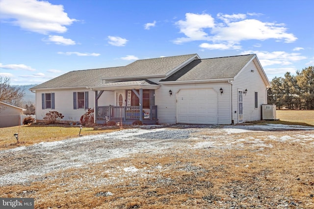 ranch-style home with a garage, covered porch, and a front lawn