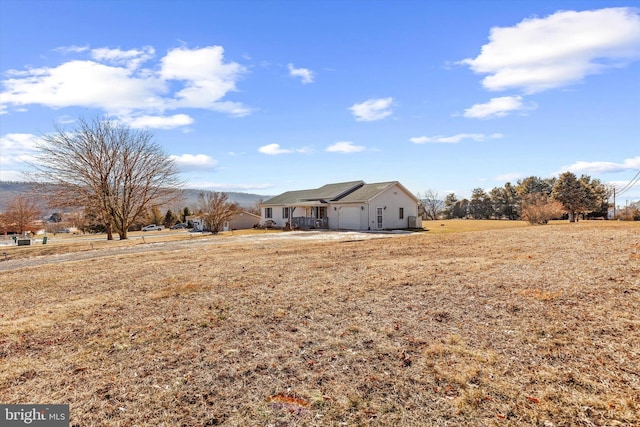 view of yard featuring a garage and a rural view