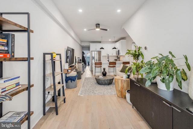 hallway with light hardwood / wood-style floors