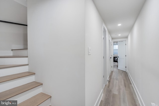 hallway with light hardwood / wood-style floors