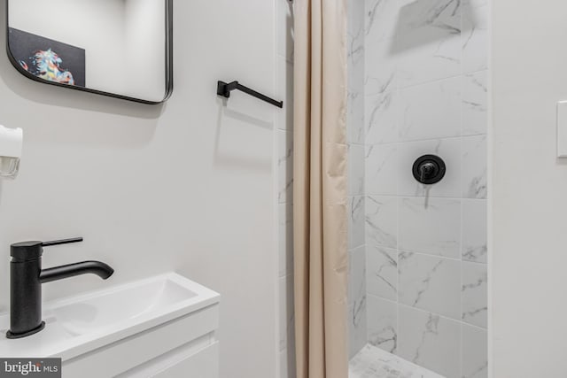 bathroom featuring sink and curtained shower