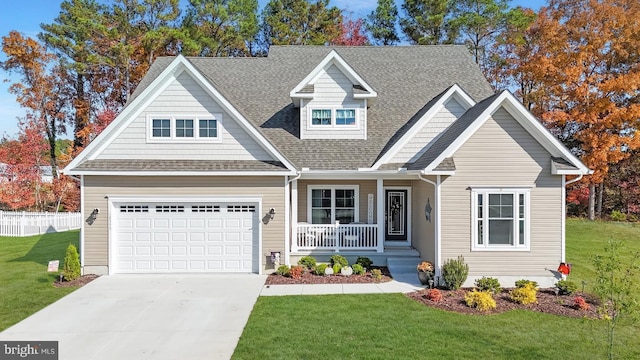 craftsman inspired home featuring a garage, covered porch, and a front lawn