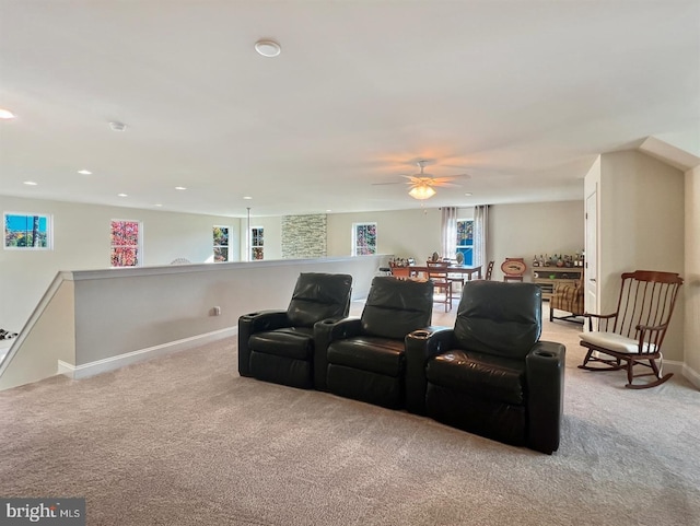 carpeted home theater with ceiling fan